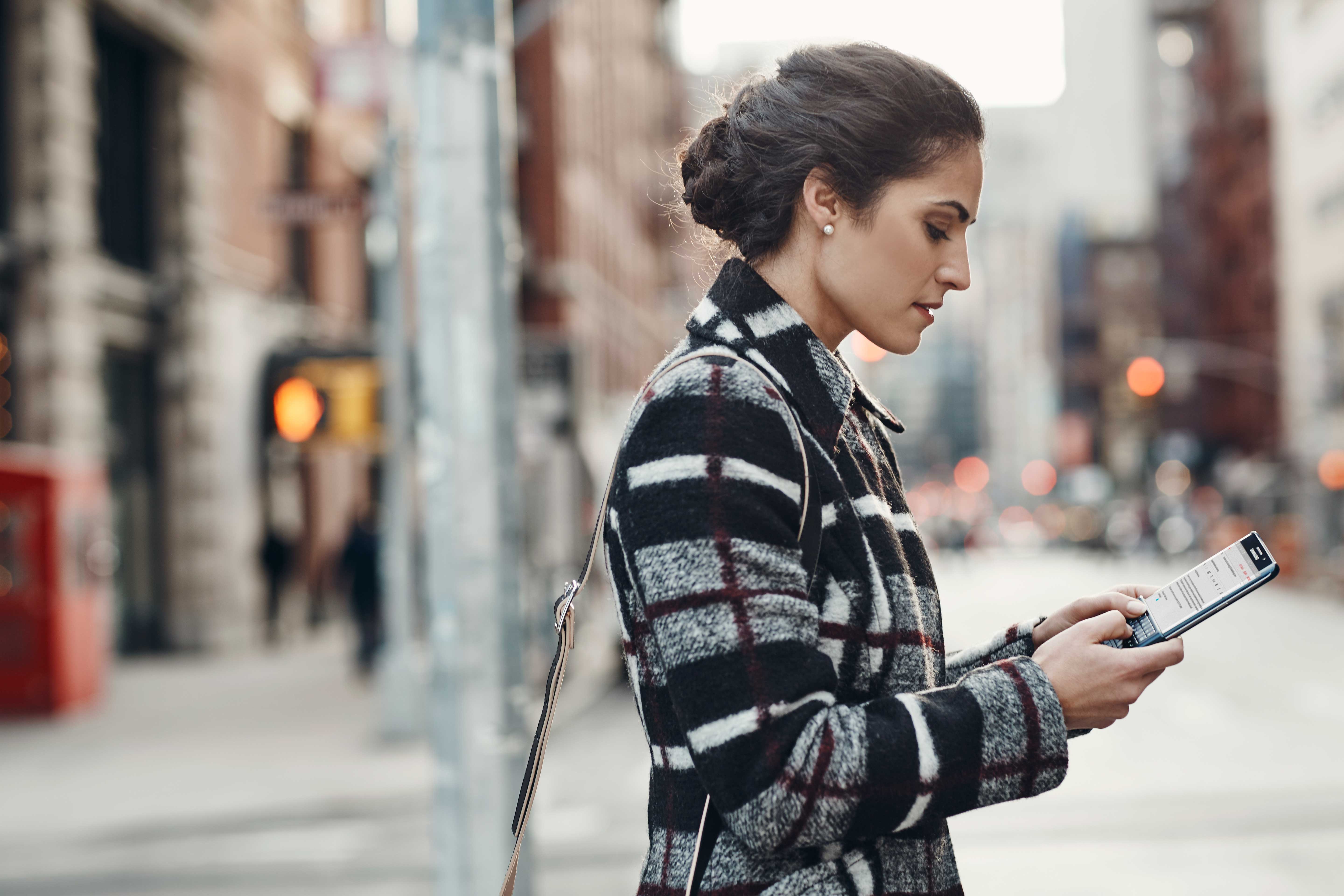 Woman using Samsung phone with hardware keypad